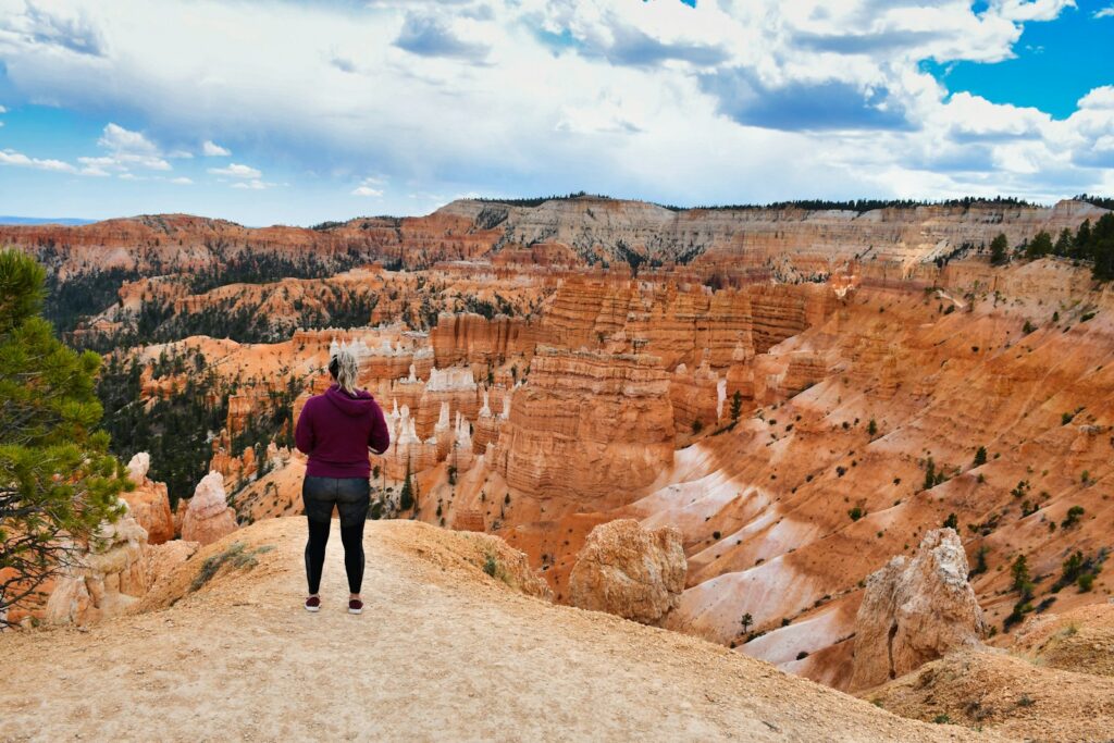 woman 
standing on a rock ledge